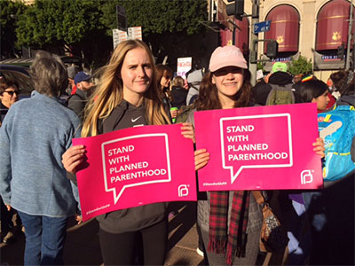 Youth Activists holding Support Planned Parenthood signs